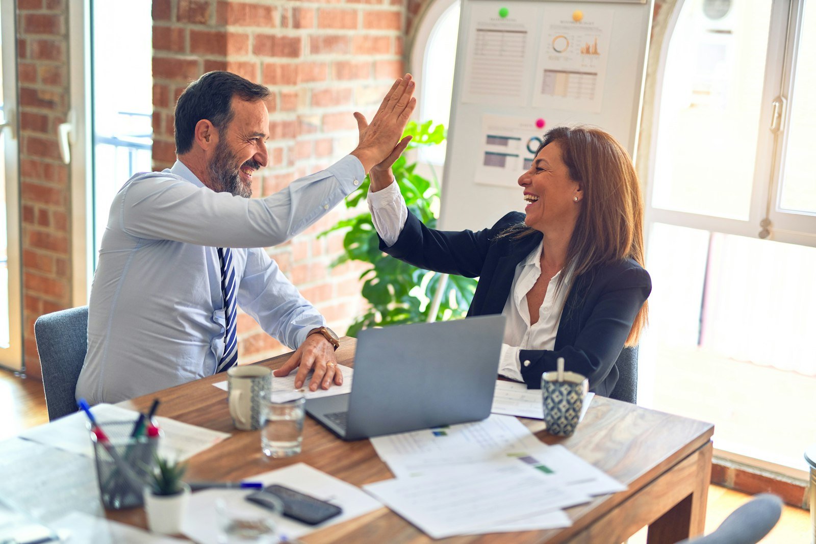 Two colleagues working together at an office desk